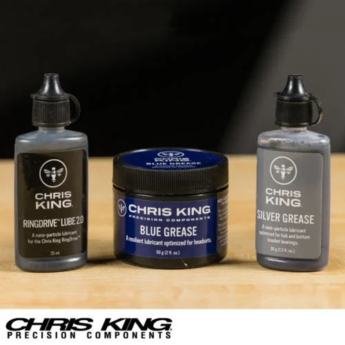 A picture showing three Chris King Bicycle component lubricants. From left to right Ring Drive Lube, blue Grease and Silver Grease.