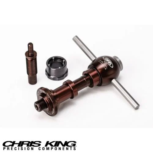 A picture showing a Chris King R45 Bicycle hub service tool in brown and black with brushed chrome handles and top cap laying flat.