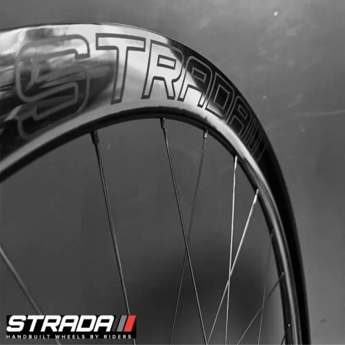 A picture showing a close up view of a the Strada Performance Aero Disc brake 55 Ultra Gloss carbon front bicycle rim.