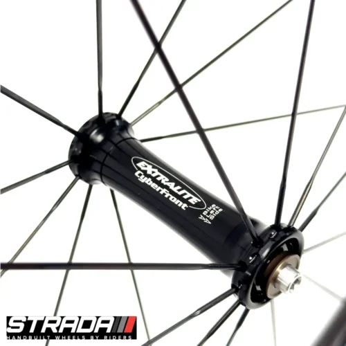 A picture showing a black extralite bicycle hub laced to a Strada Performance Aero Rim brake 30 Ultra carbon front bicycle wheel.