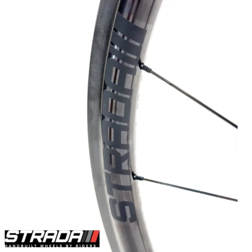 A picture showing a close up view of a the Strada Performance Aero Rim brake 30 Ultra carbon front bicycle rim.