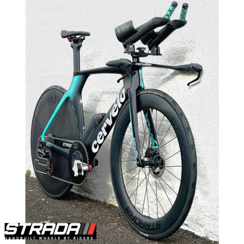 A picture showing a carbon Strada Ultra TT Disc disc Brake rear wheel in a raw carbon finish with a custom Strada S shape logo attached to a Cervelo P5 Time Trail Bicycle in Black and Light Teal.